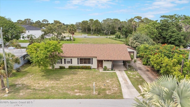 1636 Dixie Way, Melbourne, FL 32935 - ranch-style home with concrete driveway, a front yard, and view of scattered trees