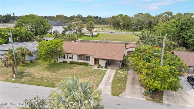 1636 Dixie Way, Melbourne, FL 32935 - view of front of home featuring concrete driveway, a front yard, and a garage