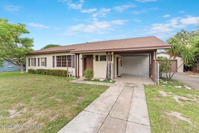 1636 Dixie Way, Melbourne, FL 32935 - single story home with concrete driveway, a front lawn, and an attached carport