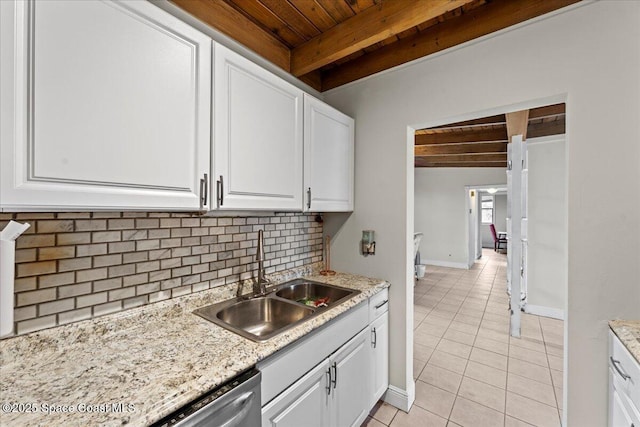 1636 Dixie Way, Melbourne, FL 32935 - kitchen featuring a wood ceiling with exposed beams, light tile patterned floors, backsplash, white cabinets, and light stone counters
