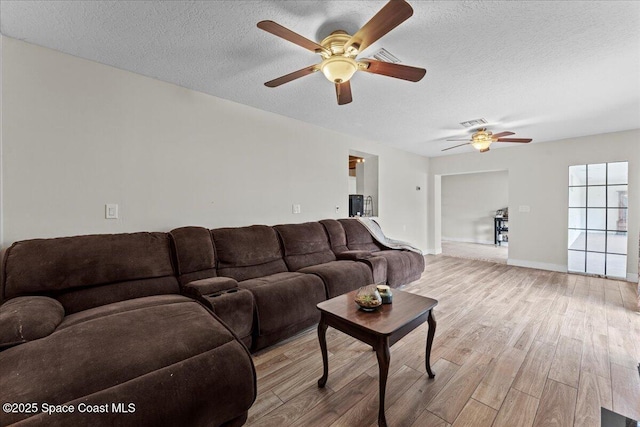 1636 Dixie Way, Melbourne, FL 32935 - living area featuring ceiling fan, wood finished floors, and a textured ceiling