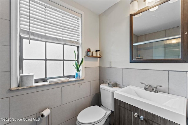 1636 Dixie Way, Melbourne, FL 32935 - bathroom featuring tile walls, vanity, a shower with door, and wainscoting