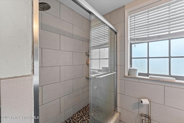 1636 Dixie Way, Melbourne, FL 32935 - bathroom featuring a shower stall and tile walls
