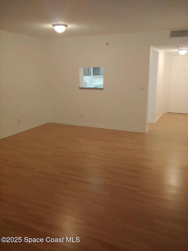 7770 Tahiti Ln Unit 208, Lake Worth, FL 33467 - spare room with light wood-style flooring and baseboards