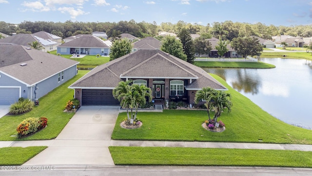 231 Nardo Ave SW, Palm Bay, FL 32908 - view of front of property with a residential view, driveway, a water view, brick siding, and an attached garage