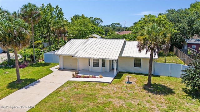 5510 Holden Rd, Cocoa, FL 32927 - view of front facade featuring a garage, concrete driveway, a porch, and a metal roof