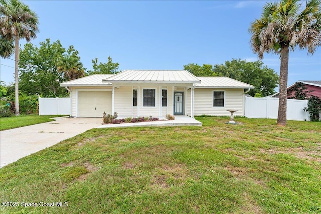5510 Holden Rd, Cocoa, FL 32927 - ranch-style home with an attached garage, driveway, a metal roof, and a standing seam roof