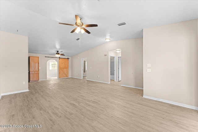 5510 Holden Rd, Cocoa, FL 32927 - unfurnished living room featuring light wood-style floors, a ceiling fan, and vaulted ceiling