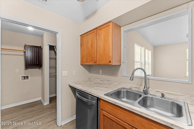 5510 Holden Rd, Cocoa, FL 32927 - kitchen featuring dishwasher, light countertops, light wood finished floors, and brown cabinets