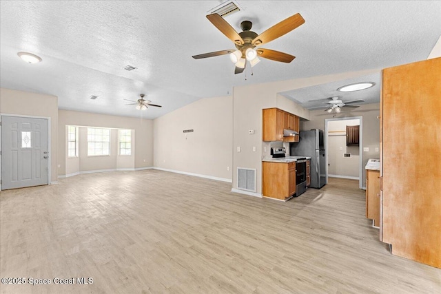 5510 Holden Rd, Cocoa, FL 32927 - unfurnished living room featuring a ceiling fan, a textured ceiling, light wood-type flooring, and vaulted ceiling