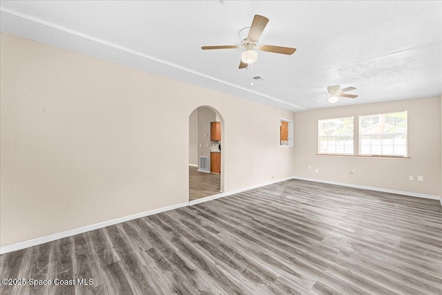 5510 Holden Rd, Cocoa, FL 32927 - unfurnished room with ceiling fan, wood finished floors, and arched walkways