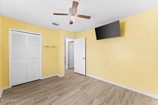 5510 Holden Rd, Cocoa, FL 32927 - unfurnished bedroom with wood finished floors, a closet, and a ceiling fan
