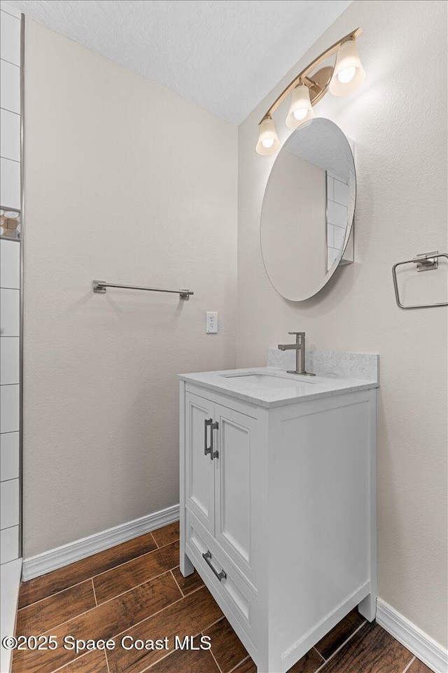 5510 Holden Rd, Cocoa, FL 32927 - bathroom with vanity, wood finished floors, and a textured ceiling
