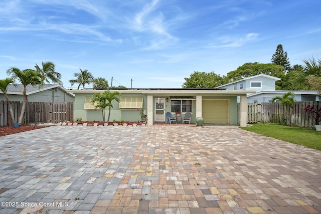 1030 S Orlando Ave, Cocoa Beach, FL 32931 - view of front of property featuring decorative driveway and an attached garage