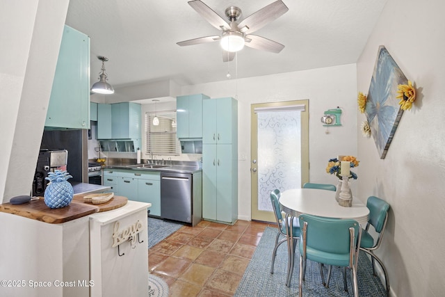 1030 S Orlando Ave, Cocoa Beach, FL 32931 - kitchen with stainless steel appliances, stainless steel counters, a ceiling fan, blue cabinetry, and light stone finish flooring