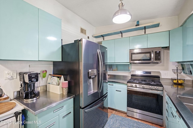 1030 S Orlando Ave, Cocoa Beach, FL 32931 - kitchen featuring stainless steel counters, stainless steel appliances, and blue cabinetry