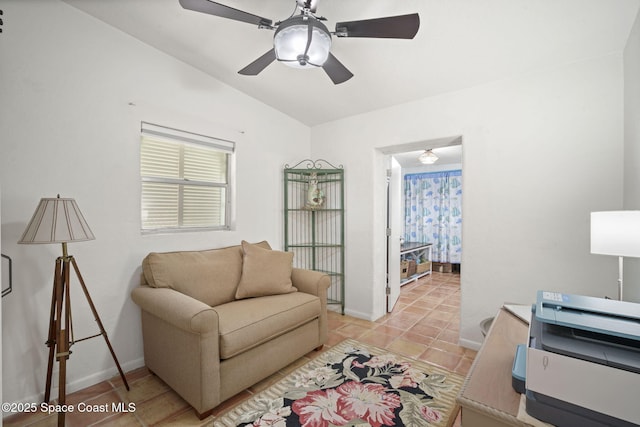 1030 S Orlando Ave, Cocoa Beach, FL 32931 - living area with lofted ceiling, light tile patterned floors, and a ceiling fan