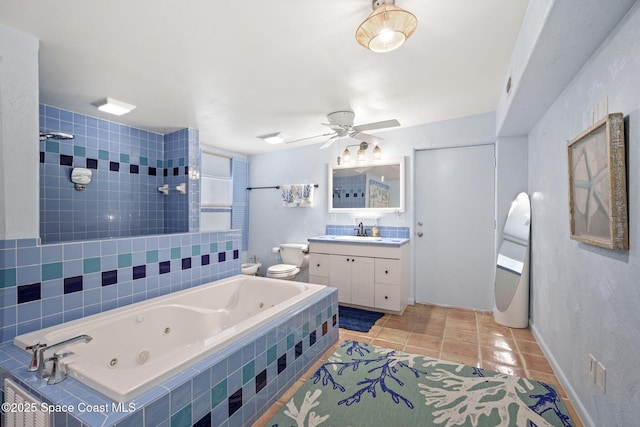 1030 S Orlando Ave, Cocoa Beach, FL 32931 - bathroom with a jetted tub, vanity, tile patterned flooring, a ceiling fan, and a tile shower