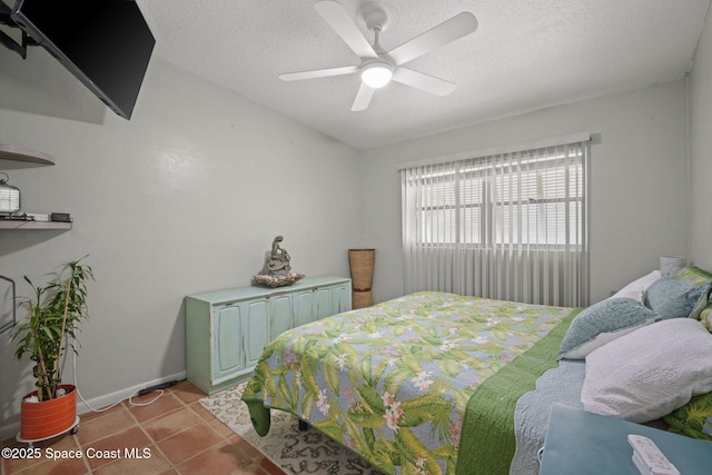 1030 S Orlando Ave, Cocoa Beach, FL 32931 - bedroom featuring a textured ceiling, a ceiling fan, and light tile patterned flooring