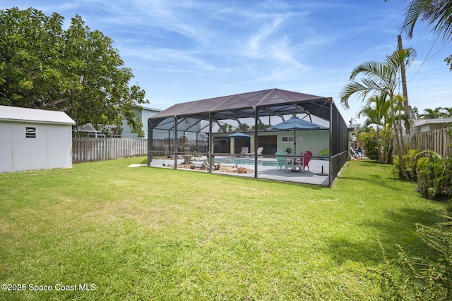 1030 S Orlando Ave, Cocoa Beach, FL 32931 - fenced backyard featuring a patio, glass enclosure, and a storage unit
