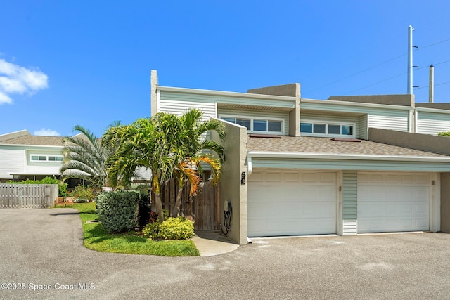 1710 Atlantic St Unit 5E, Melbourne Beach, FL 32951 - townhome / multi-family property featuring asphalt driveway, a garage, stucco siding, and roof with shingles
