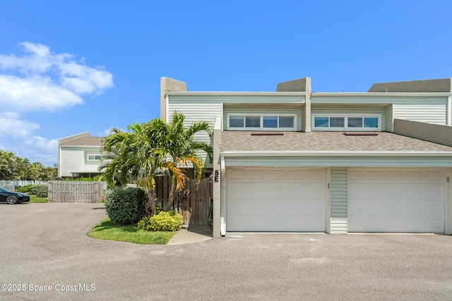 1710 Atlantic St Unit 5E, Melbourne Beach, FL 32951 - townhome / multi-family property with a garage, driveway, and a shingled roof