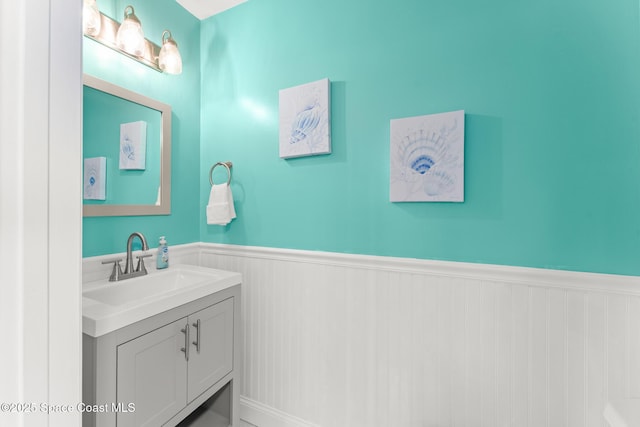 1710 Atlantic St Unit 5E, Melbourne Beach, FL 32951 - bathroom with wainscoting and vanity
