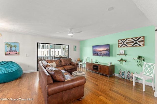 1710 Atlantic St Unit 5E, Melbourne Beach, FL 32951 - living room with wood finished floors and a ceiling fan
