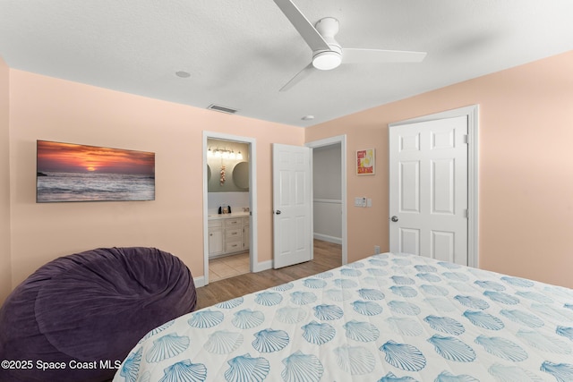 1710 Atlantic St Unit 5E, Melbourne Beach, FL 32951 - bedroom with wood finished floors, connected bathroom, and ceiling fan