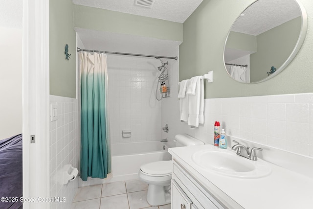 1710 Atlantic St Unit 5E, Melbourne Beach, FL 32951 - full bath with tile walls, shower / bath combo with shower curtain, vanity, a textured ceiling, and wainscoting