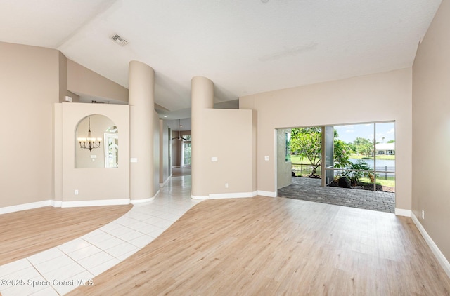 465 Apache Trl, Merritt Island, FL 32953 - unfurnished living room featuring light wood finished floors, lofted ceiling, and a chandelier