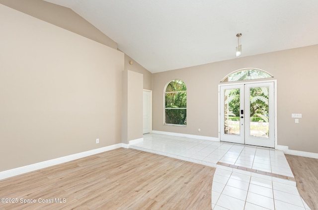 465 Apache Trl, Merritt Island, FL 32953 - empty room featuring lofted ceiling, light wood finished floors, and french doors