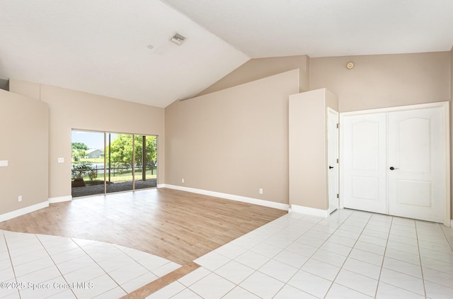 465 Apache Trl, Merritt Island, FL 32953 - empty room featuring light wood finished floors and high vaulted ceiling
