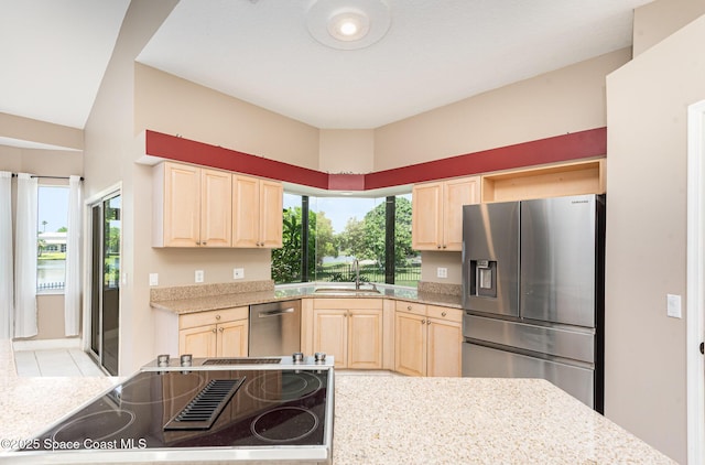 465 Apache Trl, Merritt Island, FL 32953 - kitchen featuring appliances with stainless steel finishes, light brown cabinetry, plenty of natural light, and light stone countertops