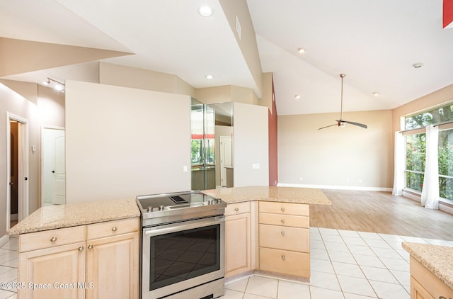 465 Apache Trl, Merritt Island, FL 32953 - kitchen featuring stainless steel electric range, light brown cabinetry, open floor plan, lofted ceiling, and a kitchen island