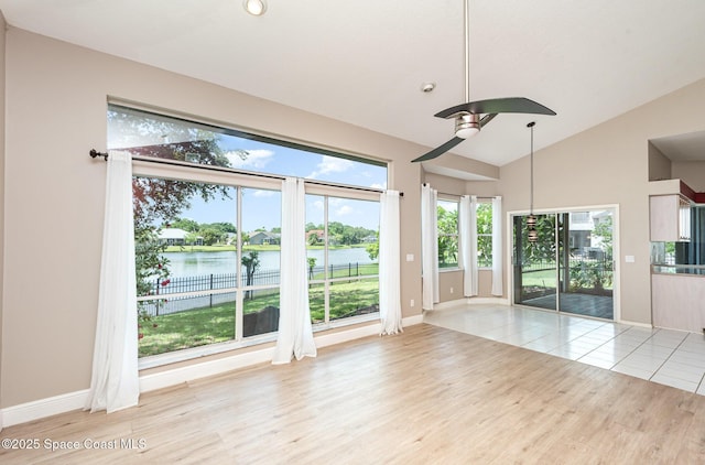 465 Apache Trl, Merritt Island, FL 32953 - unfurnished room featuring wood finished floors, a water view, lofted ceiling, a ceiling fan, and plenty of natural light
