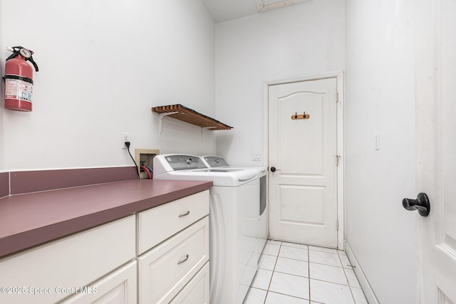 465 Apache Trl, Merritt Island, FL 32953 - washroom with washer and clothes dryer, light tile patterned flooring, and cabinet space