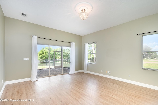 465 Apache Trl, Merritt Island, FL 32953 - spare room featuring light wood finished floors and a chandelier