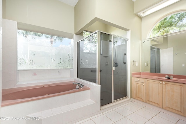 465 Apache Trl, Merritt Island, FL 32953 - full bathroom featuring a bath, vanity, tile patterned flooring, a shower stall, and healthy amount of natural light