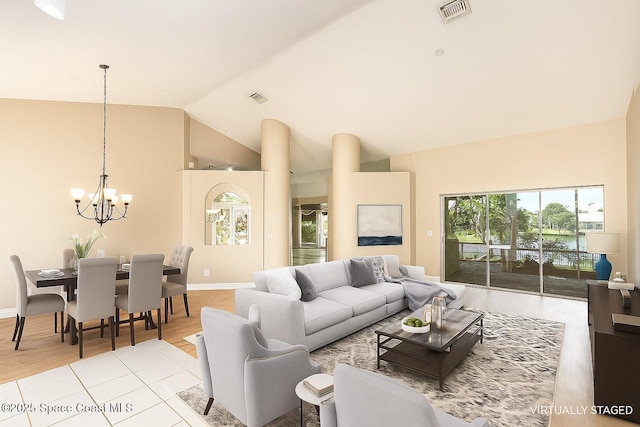465 Apache Trl, Merritt Island, FL 32953 - living room with a chandelier, wood finished floors, and high vaulted ceiling