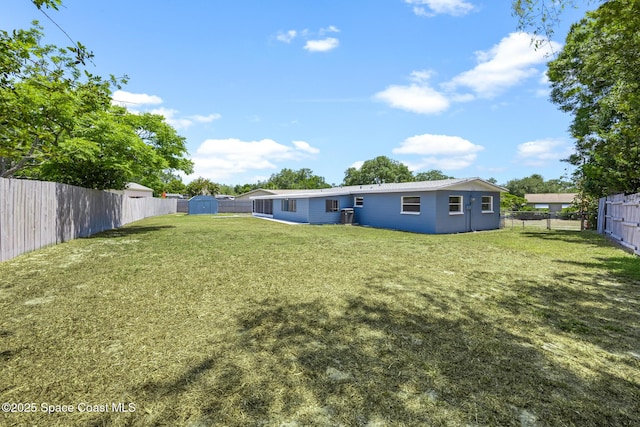 2812 Denison Ct, Cocoa, FL 32926 - rear view of house with a storage unit and a fenced backyard