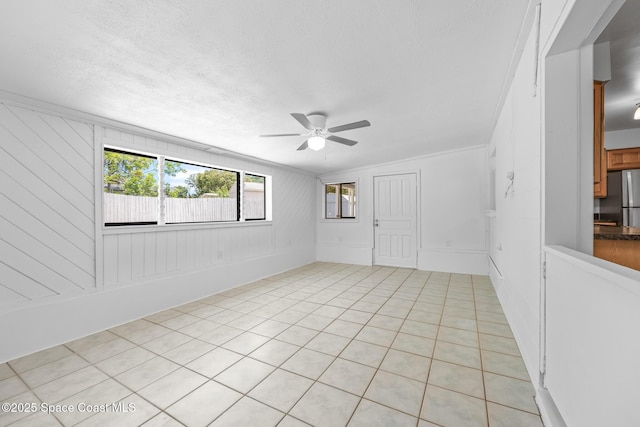 2812 Denison Ct, Cocoa, FL 32926 - spare room featuring a ceiling fan, light tile patterned floors, a decorative wall, and a textured ceiling