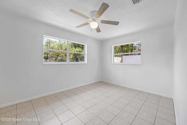 2812 Denison Ct, Cocoa, FL 32926 - empty room with healthy amount of natural light, a textured ceiling, a ceiling fan, and light tile patterned floors