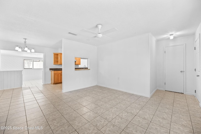 2812 Denison Ct, Cocoa, FL 32926 - unfurnished living room with a textured ceiling, a chandelier, a ceiling fan, and light tile patterned floors