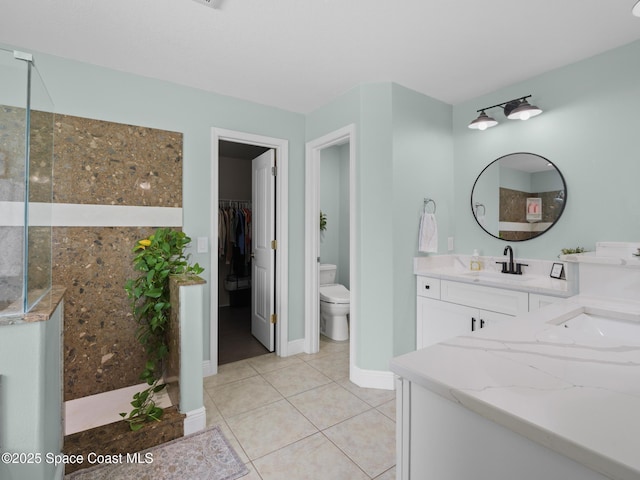 3662 Brantley Cir, Rockledge, FL 32955 - bathroom with vanity, a walk in closet, and tile patterned flooring
