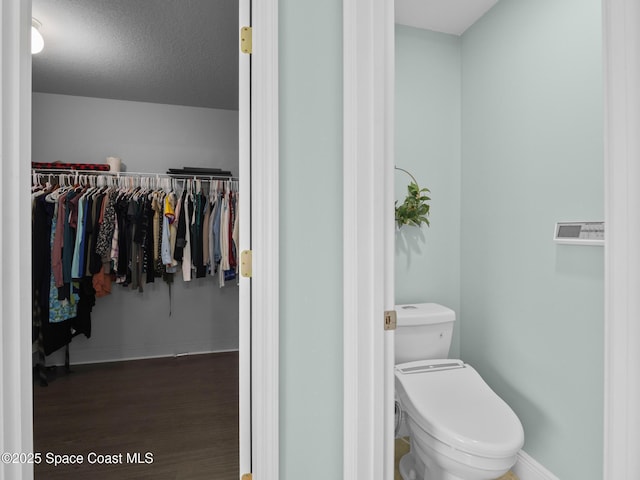 3662 Brantley Cir, Rockledge, FL 32955 - bathroom with wood finished floors and a walk in closet