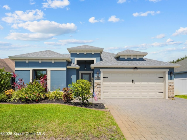 3662 Brantley Cir, Rockledge, FL 32955 - prairie-style house with an attached garage, decorative driveway, a front lawn, stucco siding, and a shingled roof