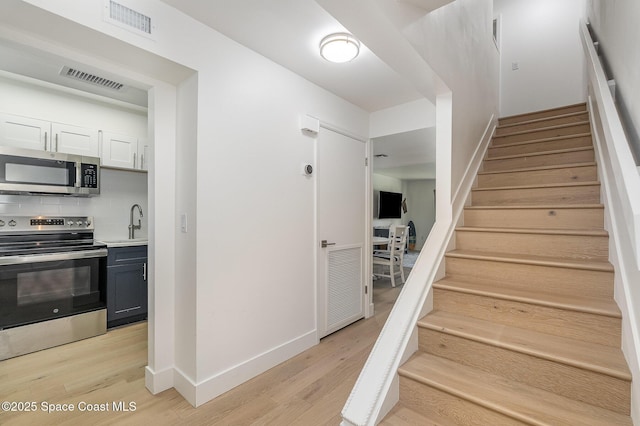 170 Paradise Blvd # 17, Indialantic, FL 32903 - staircase featuring wood finished floors