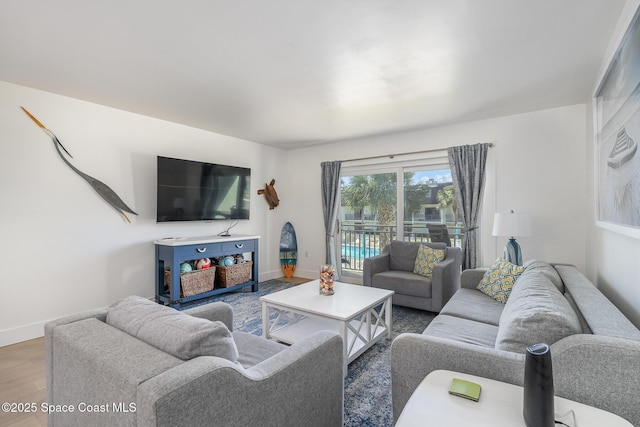 170 Paradise Blvd # 17, Indialantic, FL 32903 - living area featuring baseboards and wood finished floors