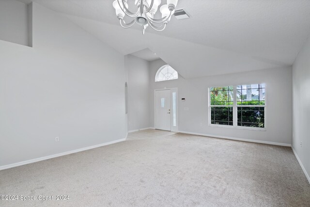621 Misty Creek Dr, Melbourne, FL 32940 - entrance foyer featuring light carpet, plenty of natural light, high vaulted ceiling, and a chandelier